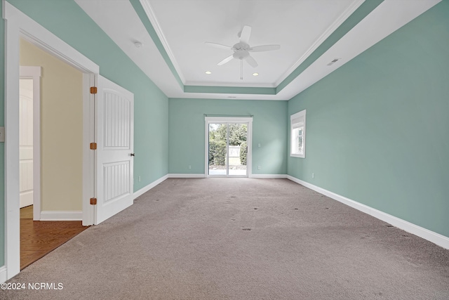 5972 Gray Squirrel Path, Southport, NC 28461 - carpeted empty room featuring a ceiling fan, a raised ceiling, baseboards, recessed lighting, and ornamental molding