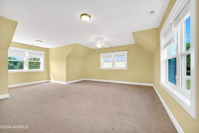 additional living space featuring carpet, vaulted ceiling, and ceiling fan