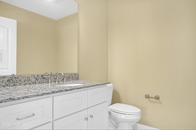 5972 Gray Squirrel Path, Southport, NC 28461 - bathroom featuring vanity, toilet, and baseboards