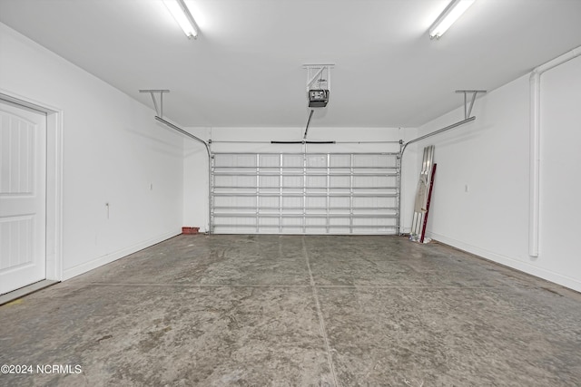 5972 Gray Squirrel Path, Southport, NC 28461 - garage with a garage door opener and baseboards
