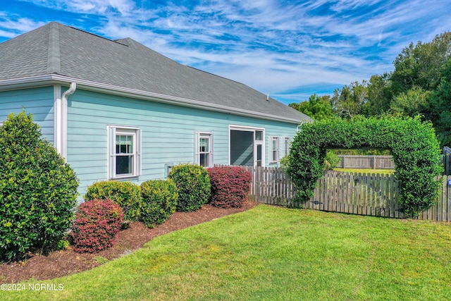 view of side of property featuring a yard