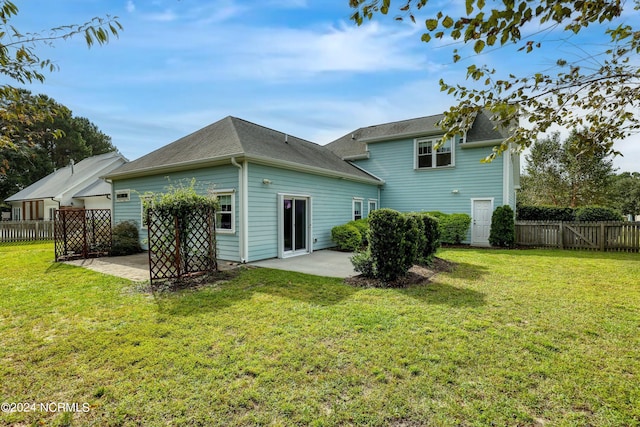 back of property with a lawn and a patio area