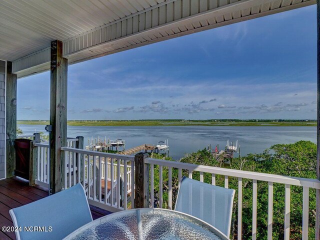 wooden deck featuring a water view