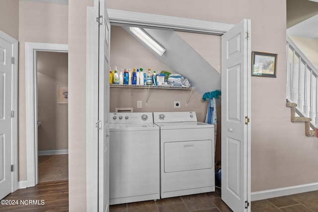 laundry room with dark wood-type flooring and washer and dryer