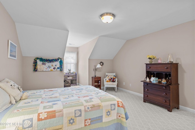 bedroom featuring lofted ceiling and light carpet