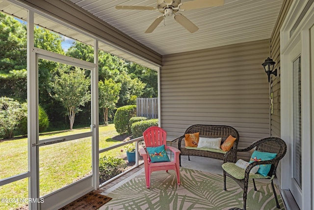 sunroom featuring ceiling fan