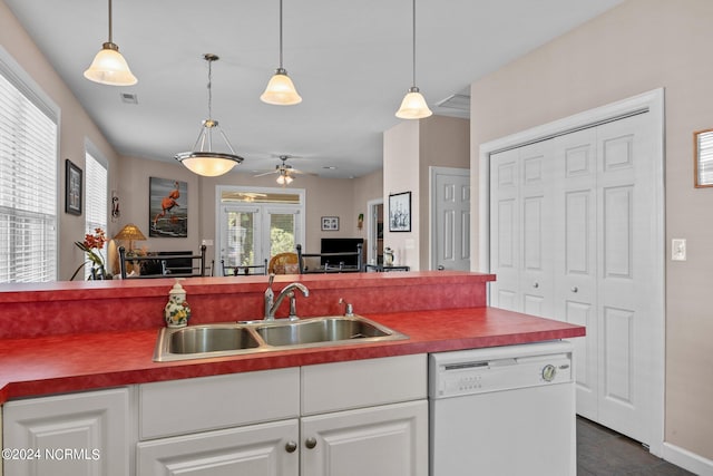 kitchen with pendant lighting, white cabinetry, white dishwasher, ceiling fan, and sink