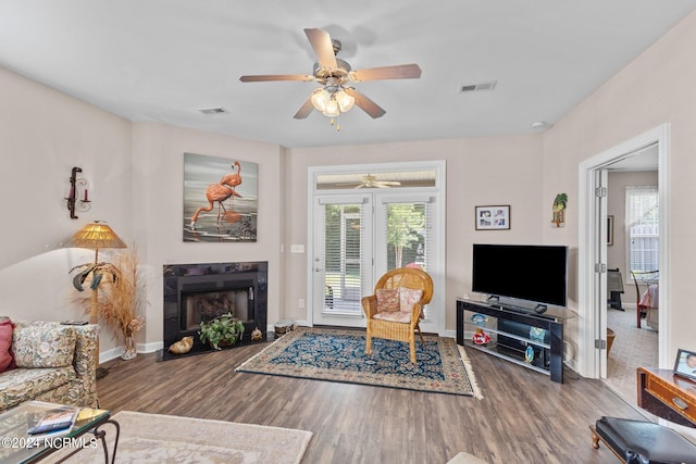 living room with hardwood / wood-style flooring and ceiling fan