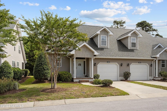 view of front of house with a front lawn and a garage