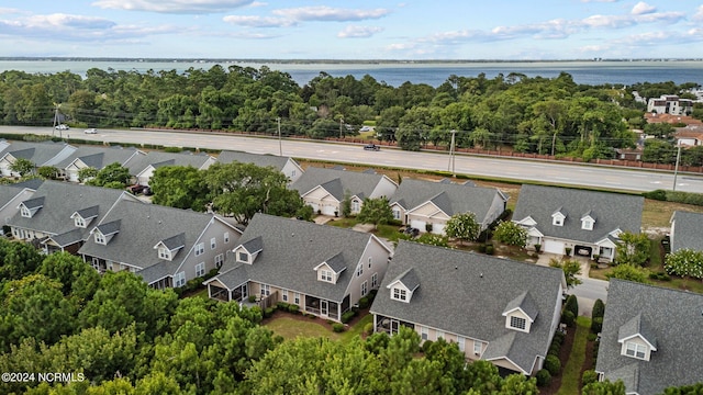 birds eye view of property with a water view