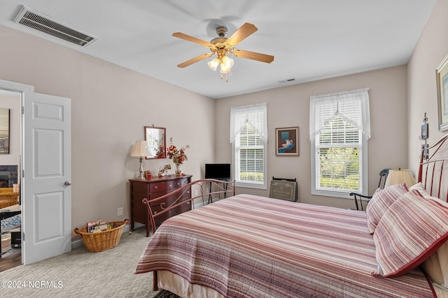 carpeted bedroom with ceiling fan