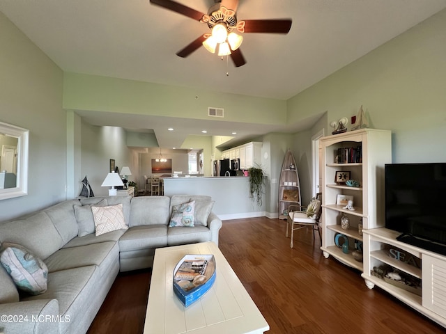 living room with dark wood-type flooring and ceiling fan