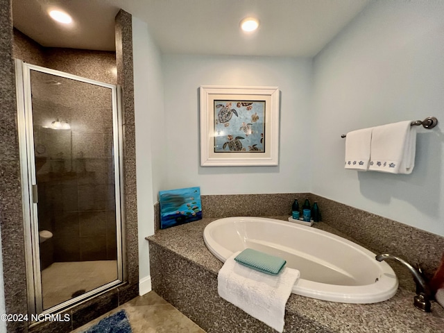 bathroom featuring tile patterned flooring and independent shower and bath