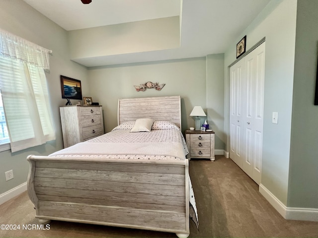 bedroom featuring dark carpet and a closet