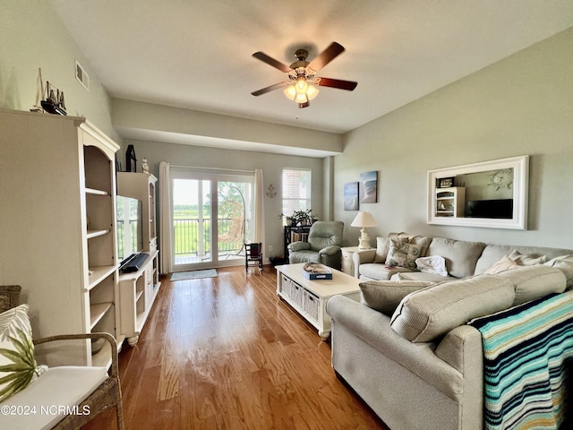 living room with ceiling fan and light hardwood / wood-style flooring