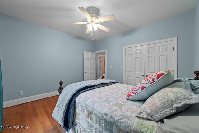 bedroom with a closet, ceiling fan, and hardwood / wood-style flooring