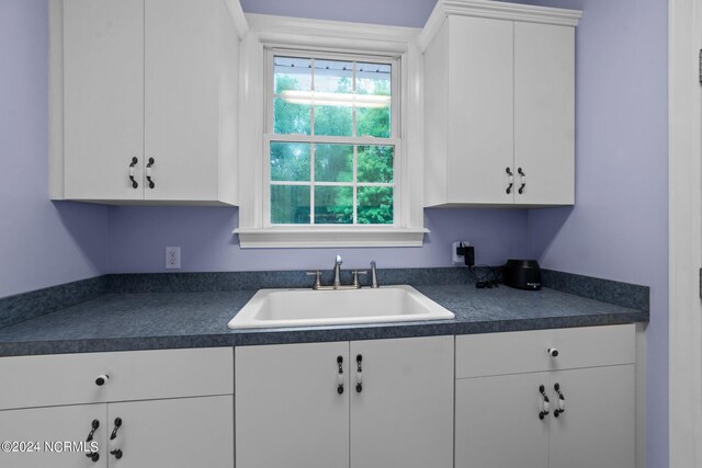 kitchen featuring sink, white cabinetry, and a healthy amount of sunlight