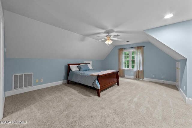 bedroom featuring ceiling fan, light carpet, and lofted ceiling