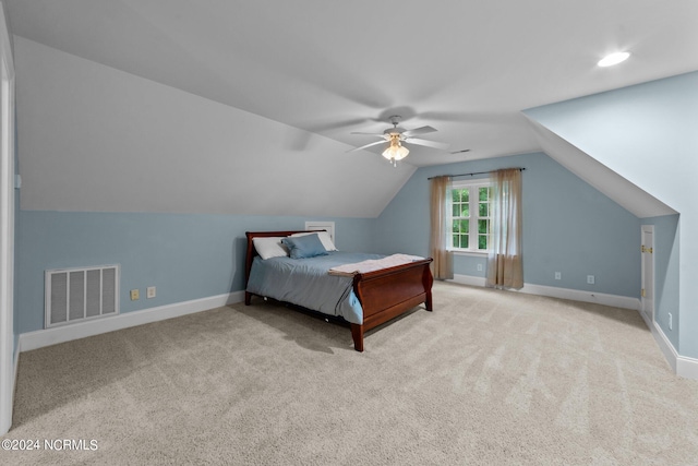 carpeted bedroom featuring visible vents, vaulted ceiling, baseboards, and ceiling fan