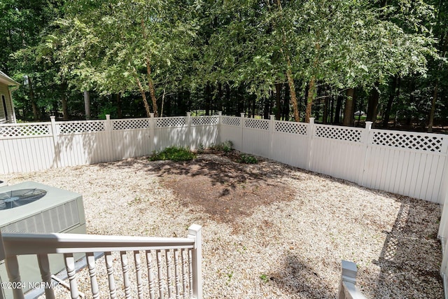 view of yard with a fenced backyard and central AC