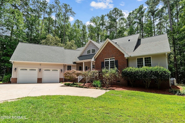 view of front of property with an attached garage, brick siding, driveway, roof with shingles, and a front yard