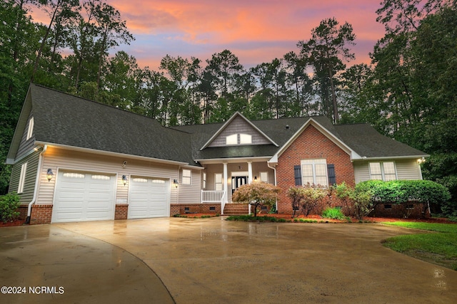 view of front facade with a garage, concrete driveway, roof with shingles, crawl space, and a porch