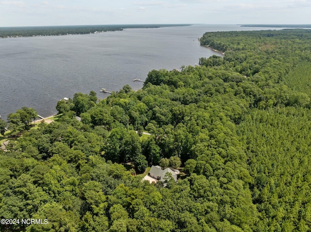 drone / aerial view featuring a water view and a forest view