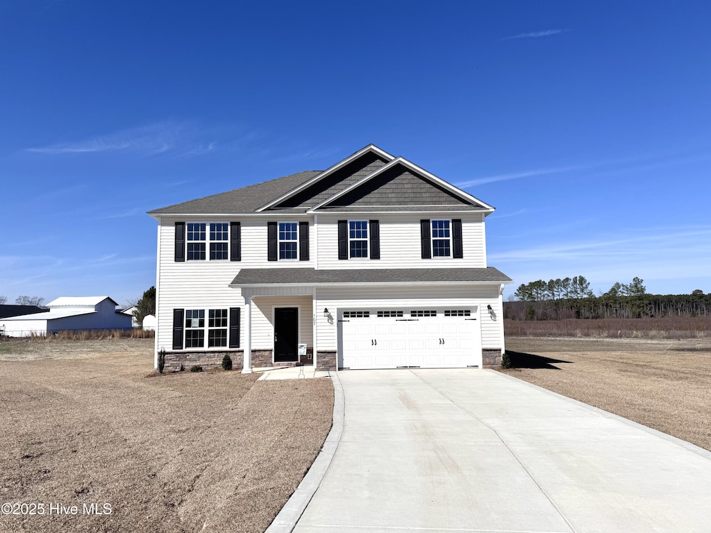 view of front of home featuring stone siding, concrete driveway, a shingled roof, and an attached garage