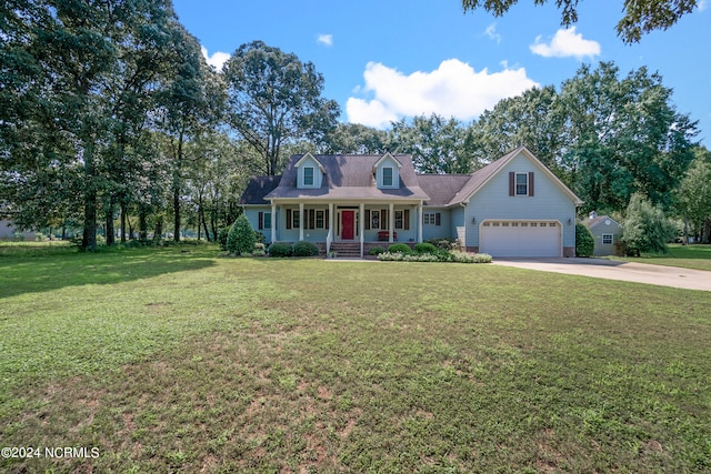 new england style home with a front lawn, covered porch, and a garage