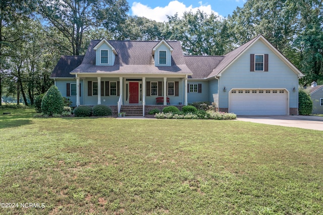 cape cod-style house featuring a porch, a front yard, and a garage