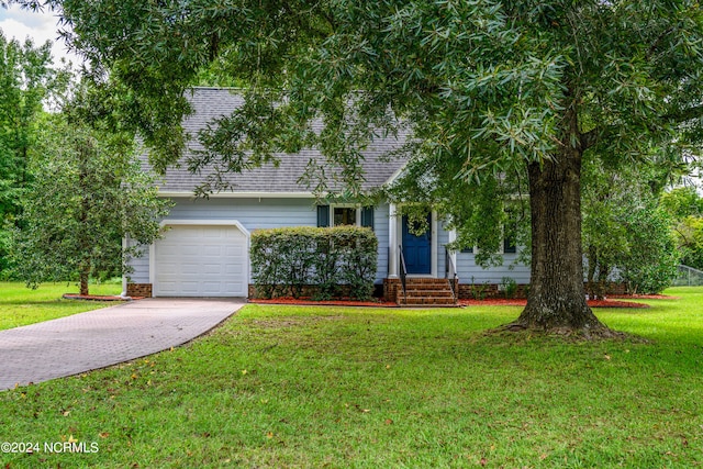 obstructed view of property featuring a front yard and a garage