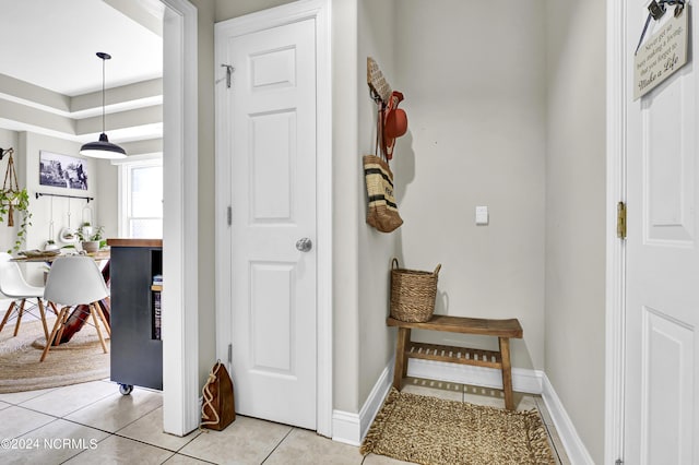 interior space with light tile patterned floors and baseboards