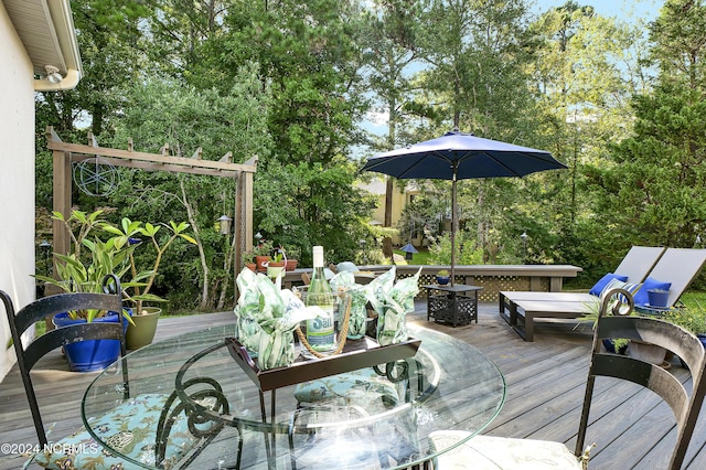 wooden deck with an outdoor fire pit and outdoor dining space