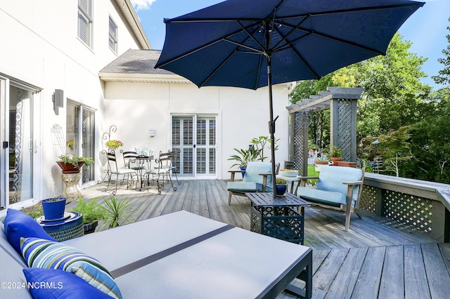 deck with a pergola and outdoor dining space