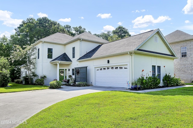 view of front of house with driveway, stucco siding, a garage, and a front yard