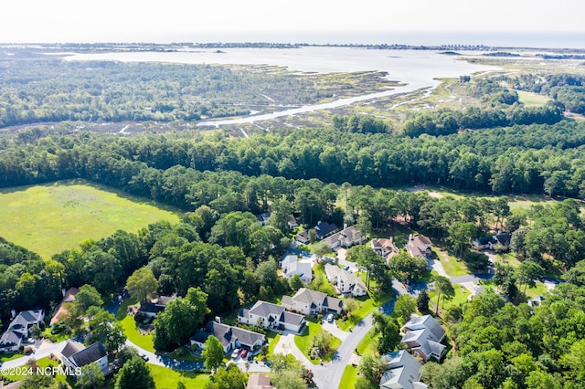 bird's eye view with a water view, a wooded view, and a residential view