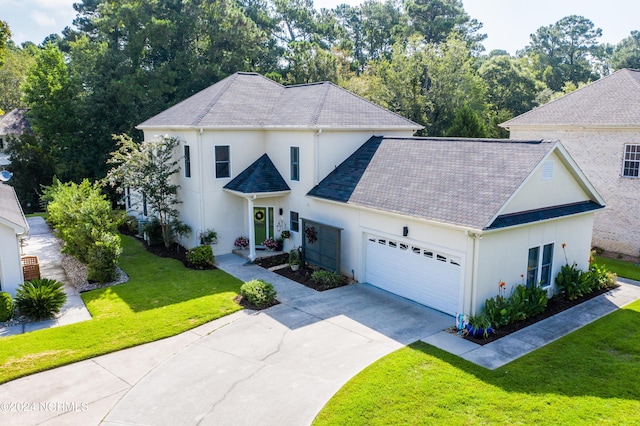 traditional home featuring driveway, a front lawn, an attached garage, and stucco siding