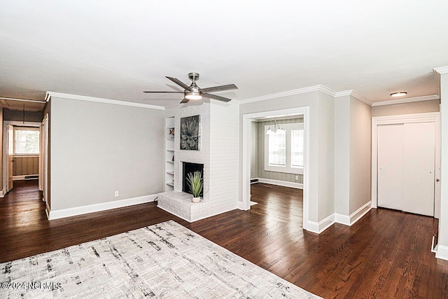 unfurnished living room with a brick fireplace, ceiling fan, crown molding, and dark hardwood / wood-style flooring