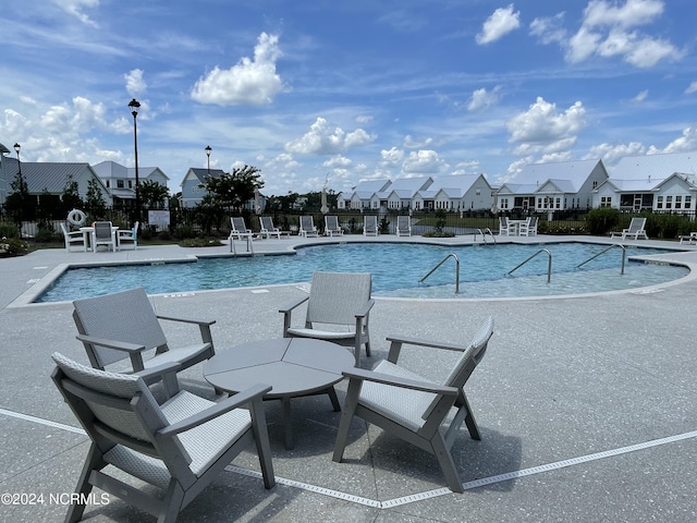 view of swimming pool featuring a patio area