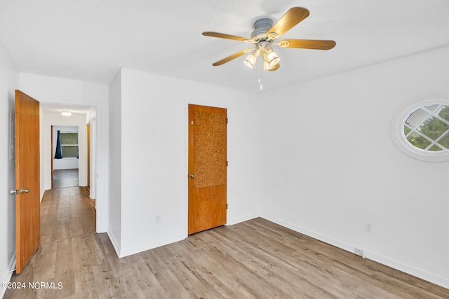 unfurnished bedroom featuring light wood-type flooring and ceiling fan