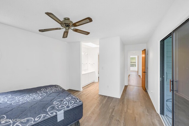 bedroom with ceiling fan, light hardwood / wood-style flooring, and ensuite bath