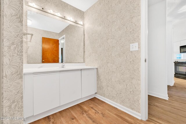 bathroom featuring hardwood / wood-style flooring and vanity