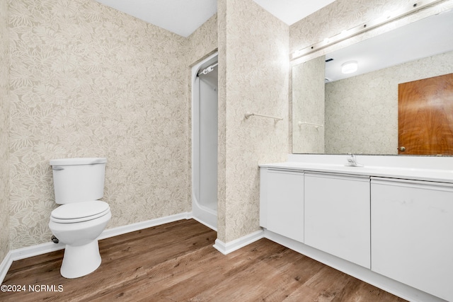 bathroom featuring hardwood / wood-style floors, vanity, and toilet