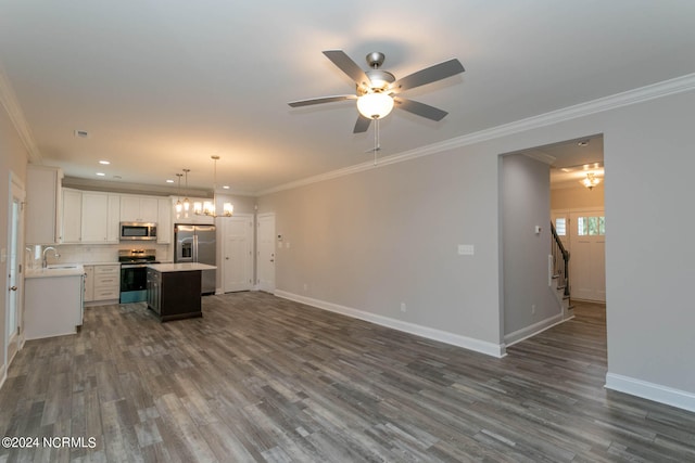 kitchen featuring a kitchen island, ceiling fan with notable chandelier, wood-type flooring, stainless steel appliances, and white cabinets