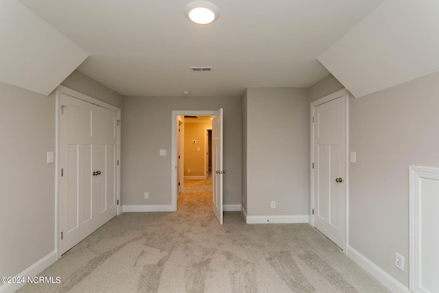 unfurnished bedroom with light colored carpet