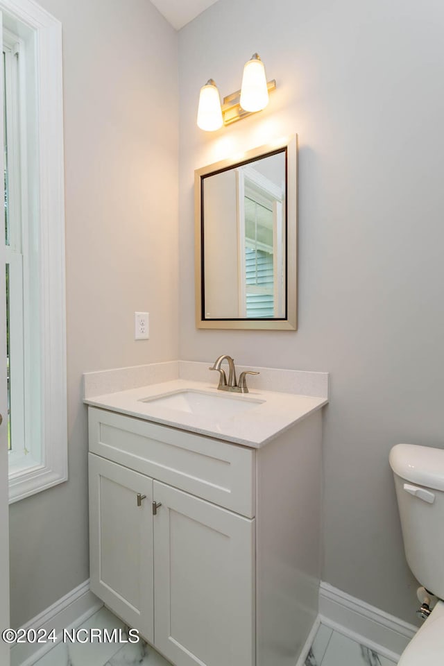 bathroom featuring vanity, toilet, and tile patterned floors