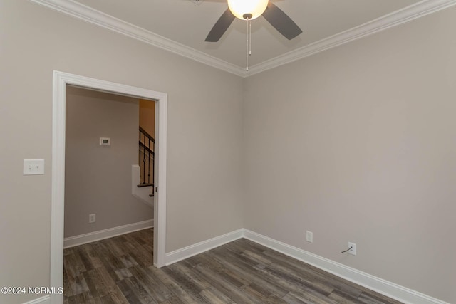 empty room with ornamental molding, dark hardwood / wood-style flooring, and ceiling fan