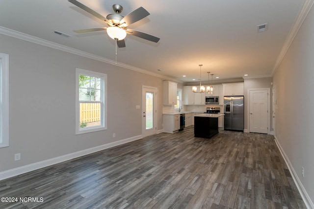 unfurnished living room with ceiling fan with notable chandelier, dark hardwood / wood-style flooring, and ornamental molding