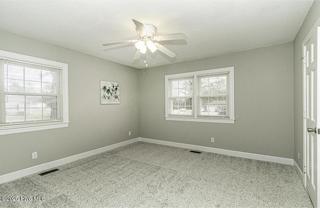 spare room with light carpet, a textured ceiling, and ceiling fan