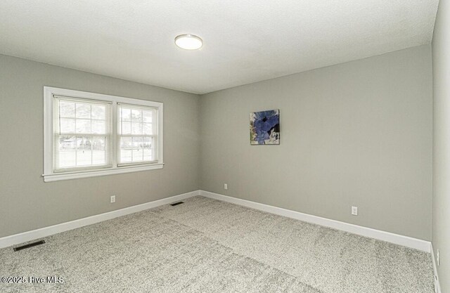 spare room featuring carpet flooring